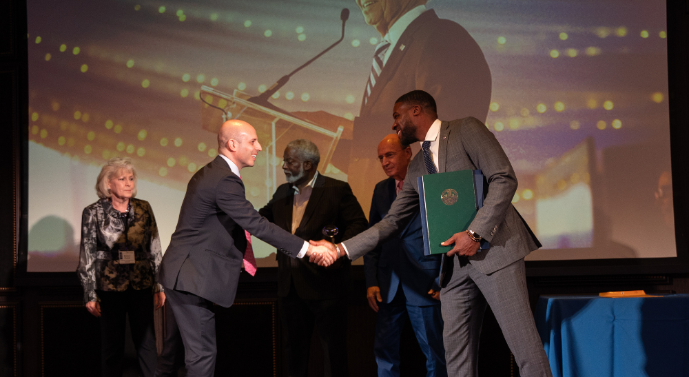 Thomas Young Shaking Honorees Hand